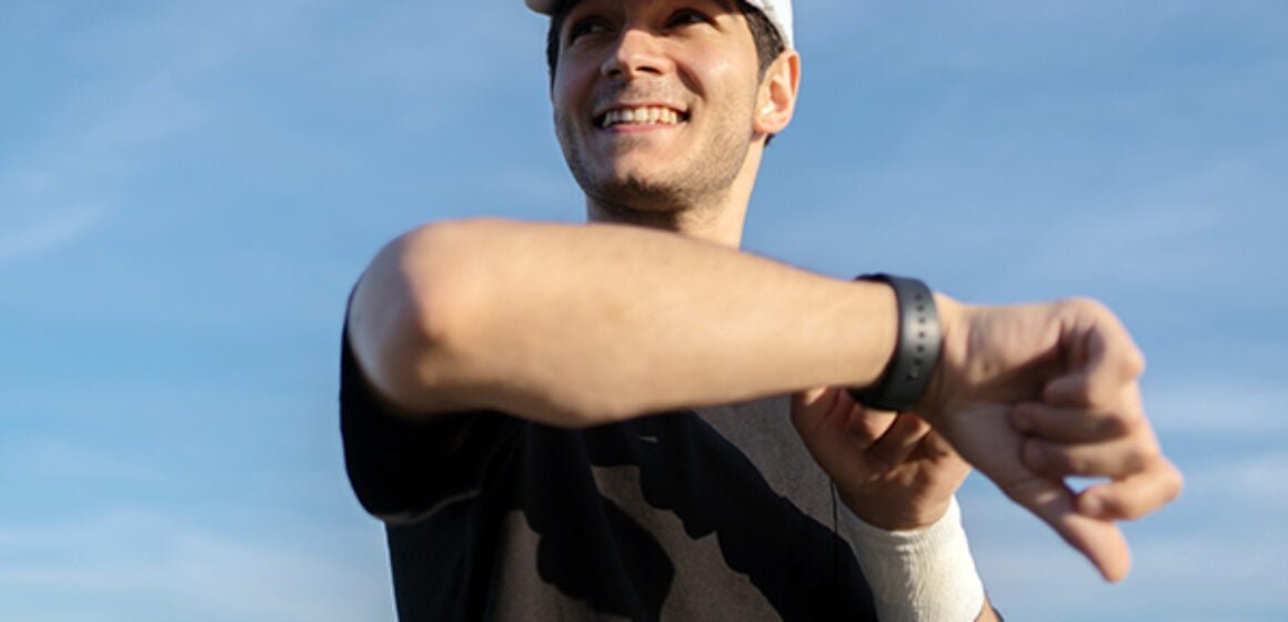 uses-a-fitness-watch-and-a-running-app-a-male-run