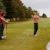 two-couples-golfing-hitting-tee-shot two-couples-golfing-hitting-tee-shot